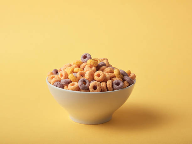 istock Breakfast cereals in bowl, on yellow background 1384997960