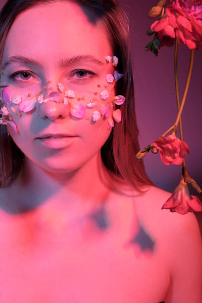 istock woman with flowers on her face 1384999358