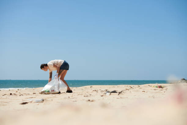 istock Woman Collecting garbage After Storm 1385009008
