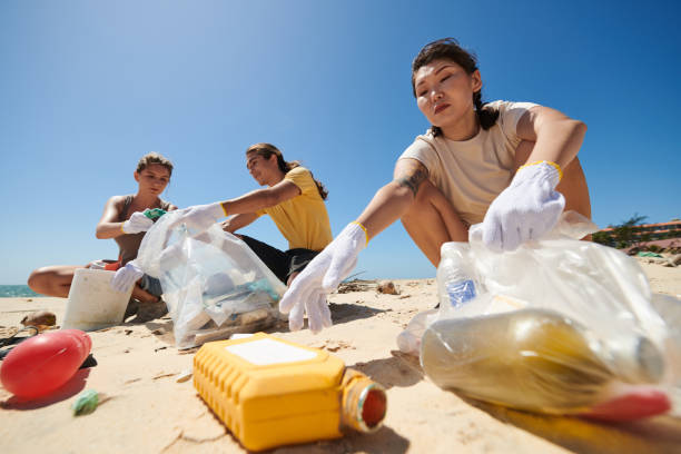 istock Friends Volunteering on Sea Beach 1385009531