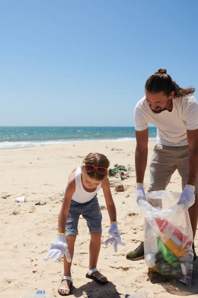 istock Girl Helping Father to Collect Garbage 1385009545