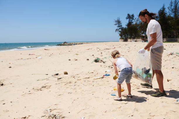 istock Father Teaching Daughter to Collect Garbage 1385009549