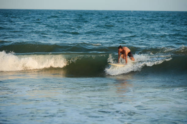 istock Fit Man Surfing in Ocean 1385009595
