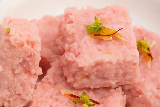Photo of Indian Mithai Rose Kalakand Also Called Pink Gulabi Milk cake Is Milk Based Sweet Made Of Curdled Khoa Doodh Khoya Chhena Khova Paneer Gulab Jal. Enjoyed On Deepawali, Rakshabandhan, Janmashtami Puja
