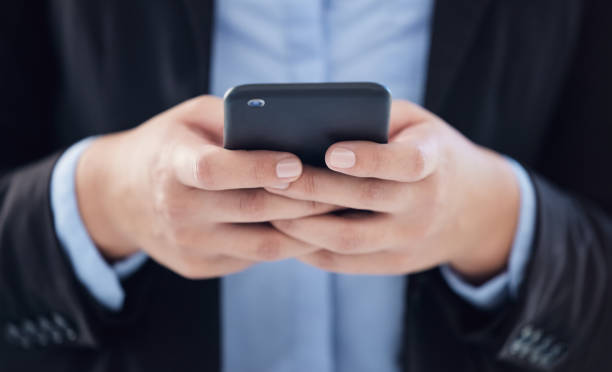 istock Shot of an unrecognizable businessman using a smartphone in a modern office 1385038010