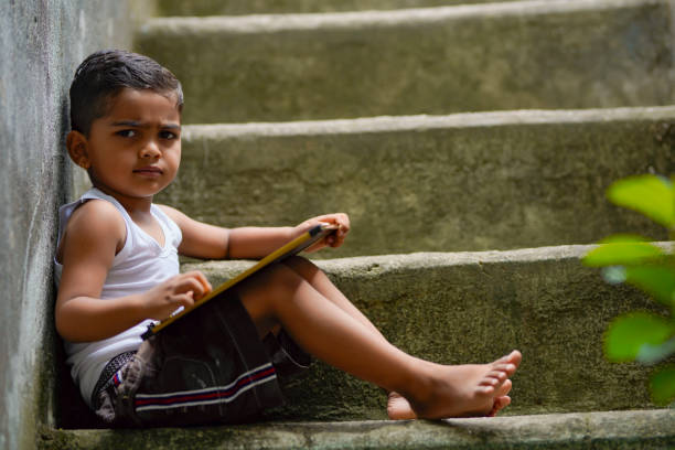Cute indian little boy studying at home