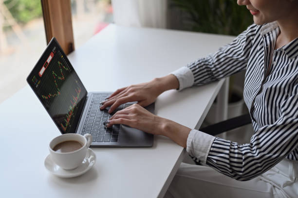 istock Female accountant analyzing financial graphs charts online on laptop screen. 1385042288