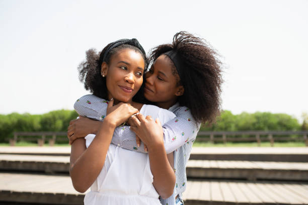 istock Young women holding each other while enjoying hanging out together. 1385042893