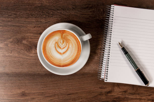 istock Coffee cup with a notebook and a fountain pen 1385045136