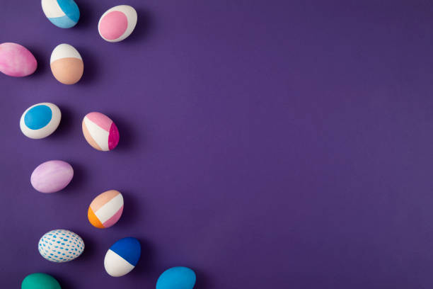 Painted colorful easter eggs on purple background