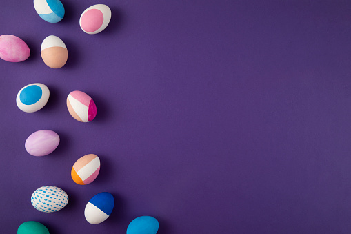 Painted Colorful Easter Eggs on Purple Background