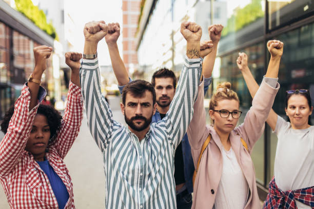 istock Group of people activists protesting on streets 1385049577
