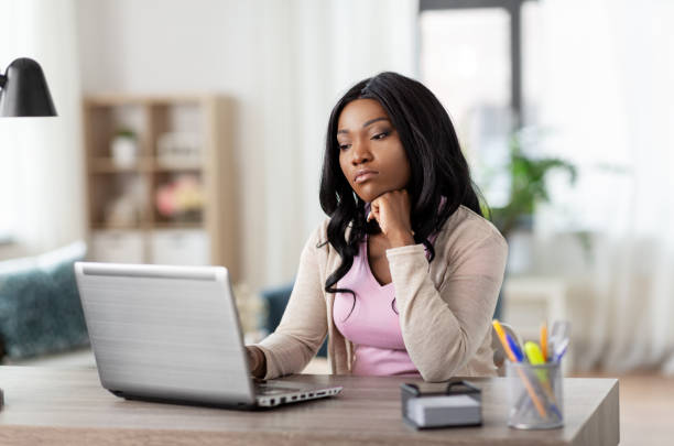istock bored woman with laptop working at home office 1385049687