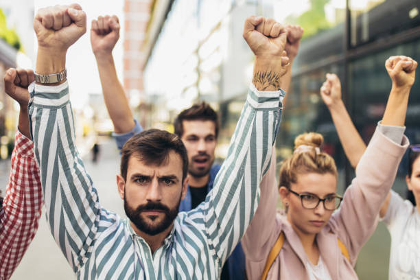 istock Group of people activists protesting on streets 1385049698