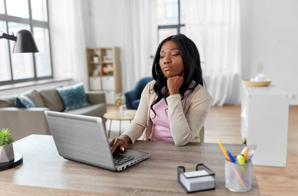 istock bored woman with laptop working at home office 1385050580