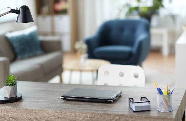 istock laptop and stationary on table at home office 1385050730