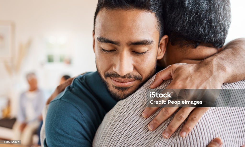 Shot of a father and son hugging at home I'll always come back for a hug Embracing Stock Photo