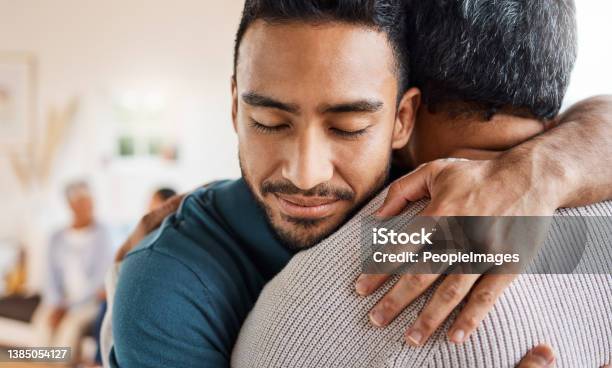 Shot Of A Father And Son Hugging At Home Stock Photo - Download Image Now - Embracing, Support, Family