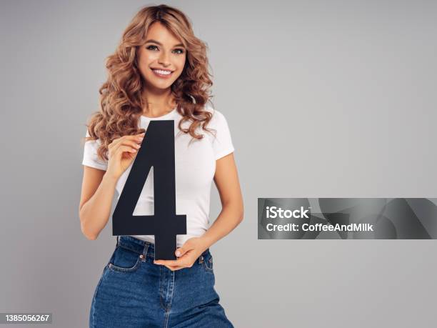 Woman Holding Artificial Figure Stock Photo - Download Image Now - Number 4, Holding, Point - Scoring