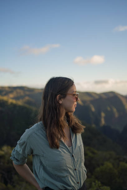 istock Female hiker relaxes at viewpoint over rainforest 1385056510