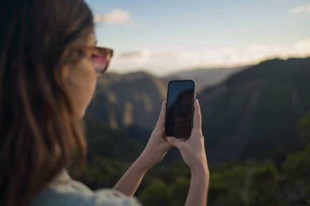 istock Female hiker relaxes at viewpoint over rainforest 1385056649