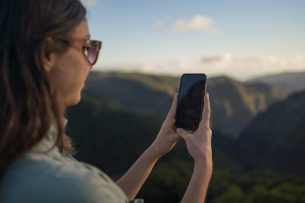 istock Female hiker relaxes at viewpoint over rainforest 1385056808