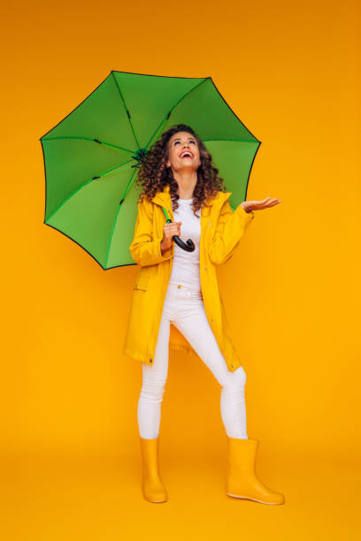 istock Girl with green umbrella 1385057888