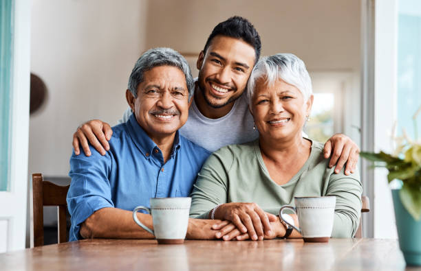 shot of a young son spending time with his parents at home - coffee cafe drinking couple imagens e fotografias de stock