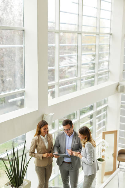 istock Young business people discussing ideas over digital tablet on staircase 1385062659