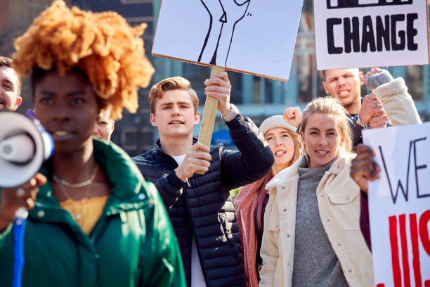 istock Protestors With Placards And Megaphone On protests Demonstration March Against Racism 1385063823