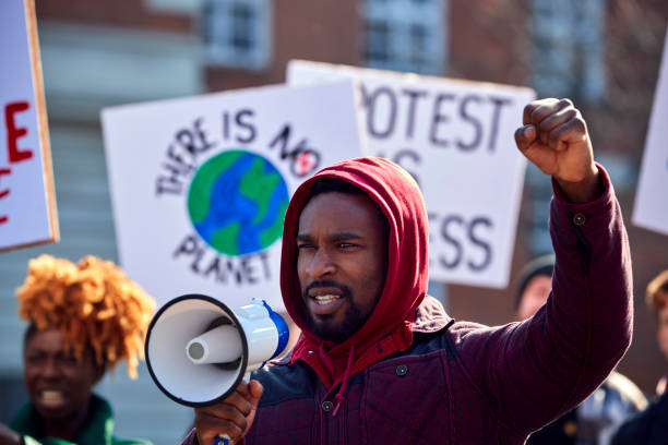 istock Group Of Protestors With Placards On Demonstration March Against Climate Chane 1385063847