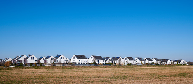 Panoramic view of a new settlement, a stubble field in the foreground, Düsseldorf, Germany.