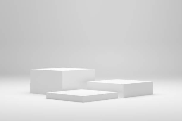 istock Blank white podium platforms or pedestals with white background for product display. Empty stands for showing or presenting products. 1385065624