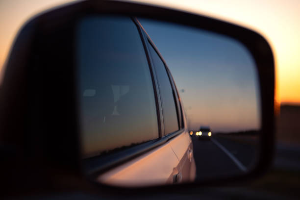 istock reflection in car rear mirror sunset on the road 1385066265