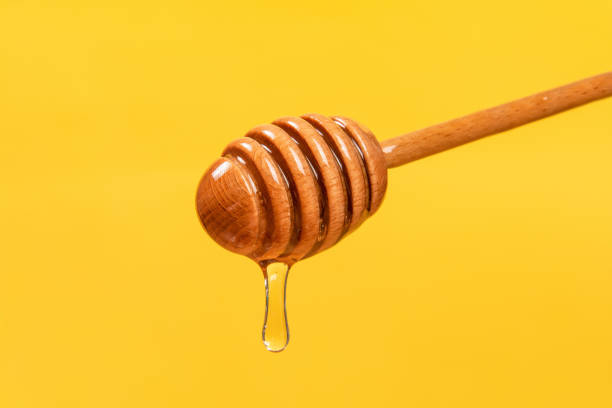 istock honey dripping from a wooden dipper 1385067273