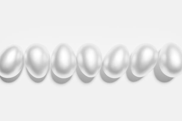 istock 3d render of shiny white eggs on a white background 1385071642