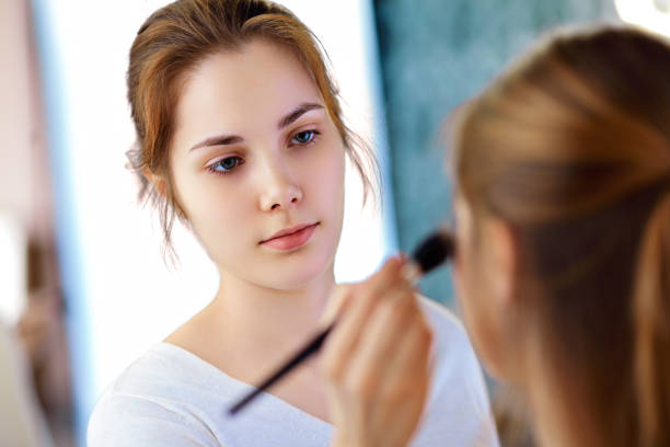 istock Make-up artist applying powder 1385074654