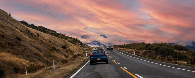 Banner of traveling  explore on the road with  sunset sky scene as mountain range near Aoraki Mount Cook and the road leading to Mount Cook Village in New zealand