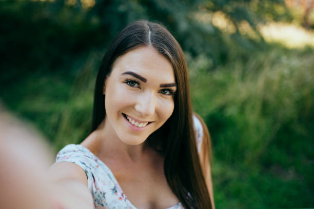 istock Girl taking selfie in the park 1385076014