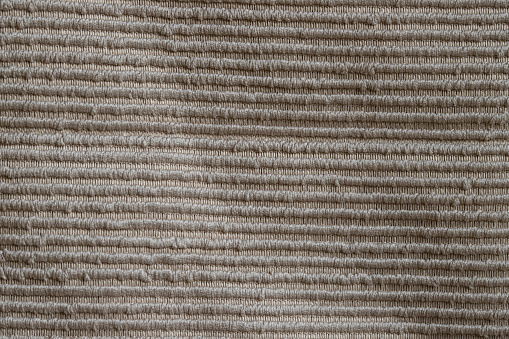 Woven carpet mat flooring pattern as background, top view