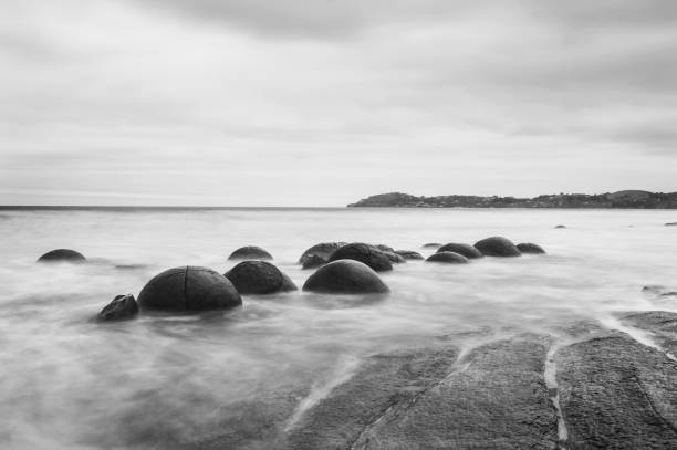 Moeraki boulders in New Zealand Moeraki Boulders on the Koekohe beach. Eastern coast of New Zealand. HDR image, black and white black and white beach stock pictures, royalty-free photos & images