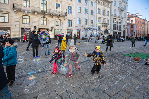 Lviv, Ukraine - March 13, 2022: Evetyday live in Lviv during russian war. Refugees, children on streets