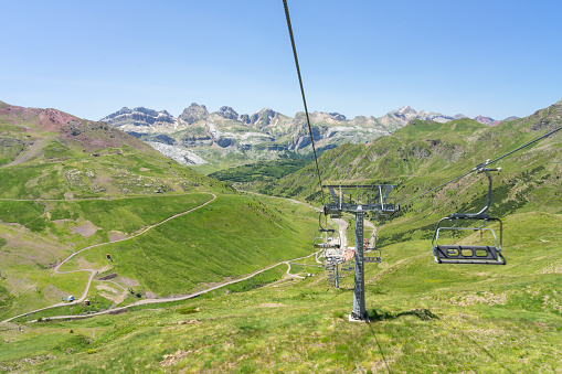 Chair lift of the Astun ski resort in summer and Lakes of Astun hike in Aragon pyrenees mountains in a suuny day