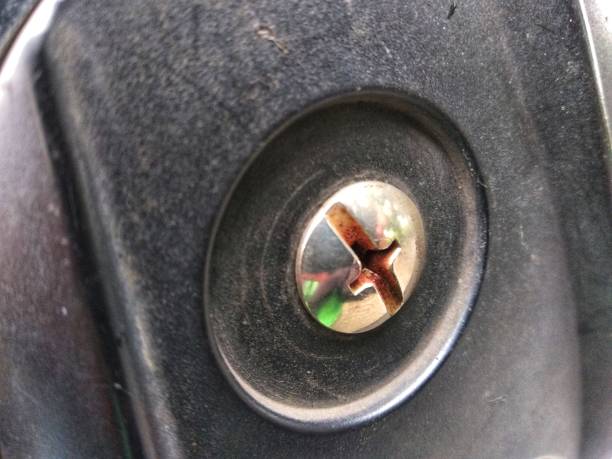 istock Closeup Old and rustic metal screw on board 1385080127