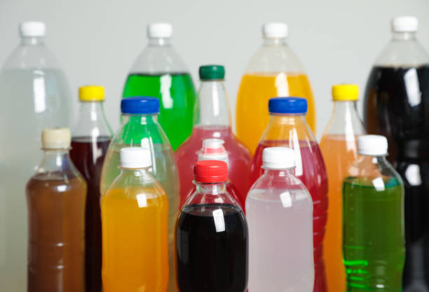 istock Bottles of soft drinks on grey background 1385080363
