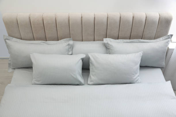 istock Many soft pillows and blanket on large comfortable bed indoors 1385080583