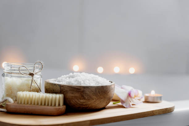 istock Hotel spa treatment or home bath procedure. Bathroom with accessories on tray 1385082380