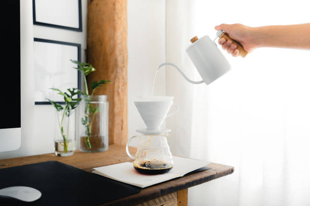 istock Drip coffee,Pouring a hot water over a drip coffee on the table 1385082443