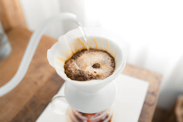 istock Drip coffee,Pouring a hot water over a drip coffee on the table 1385082452