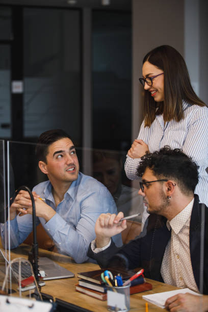 istock Three young business people discussing strategy for a project they are co-working on 1385086789